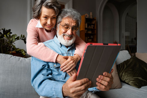 Couple staring at a tablet